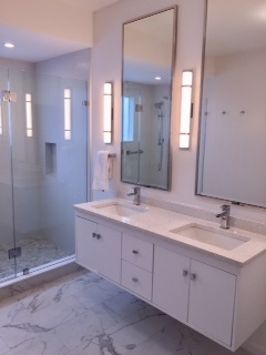 A beautifully remodeled bathroom in a home, showcasing luxury fixtures and water-efficient design