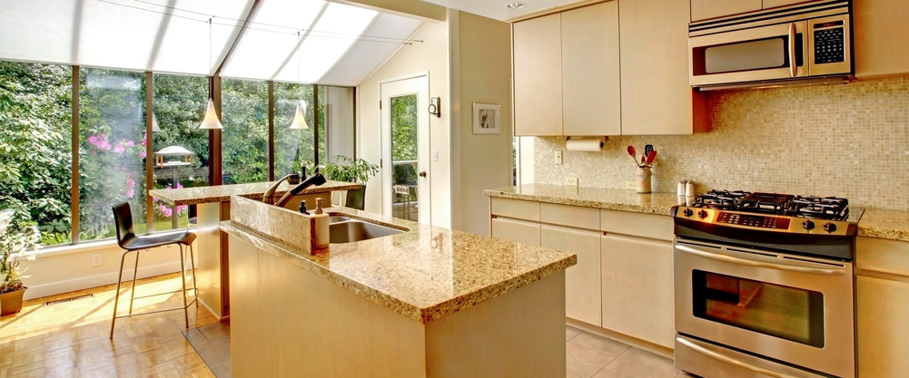 Bright and modern kitchen renovation with open, airy design and granite countertops.