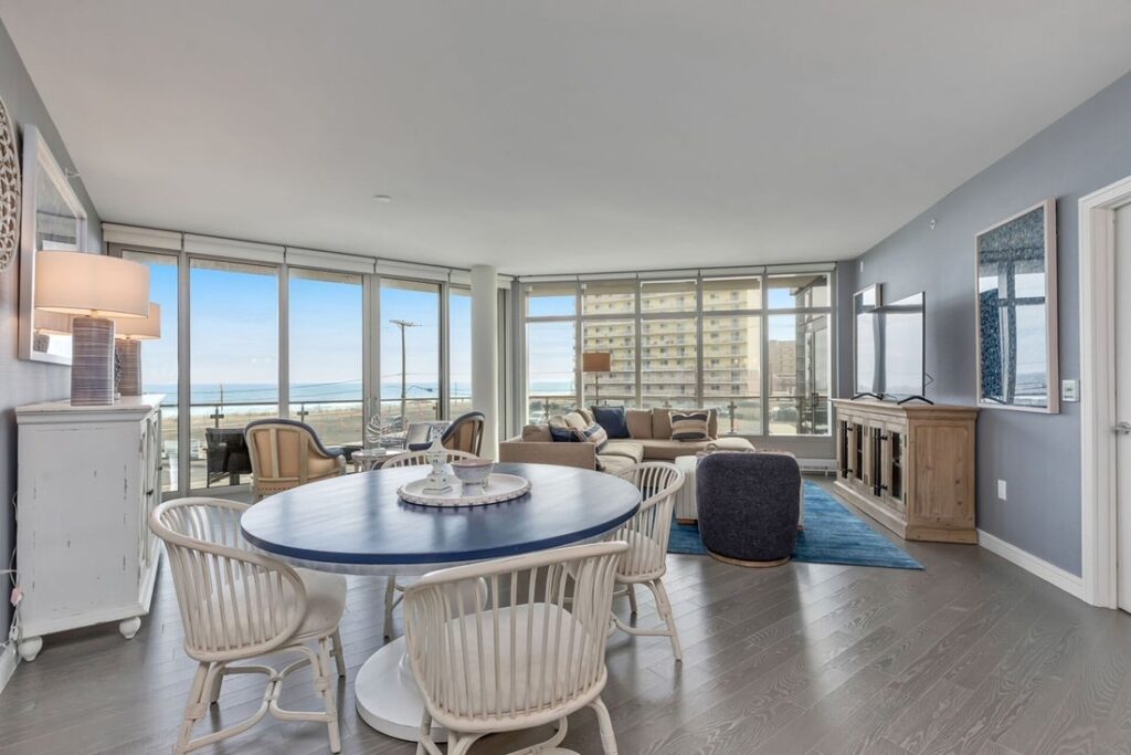 Modern living room with ocean views, neutral tones, and open floor plan design.