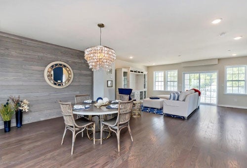 Spacious living area with a modern furniture layout and natural lighting.