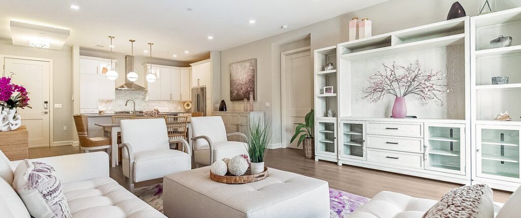 Modern living room design with neutral tones, custom shelving.