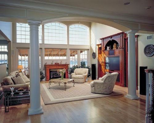 Spacious living room with elegant columns and large windows for natural light.