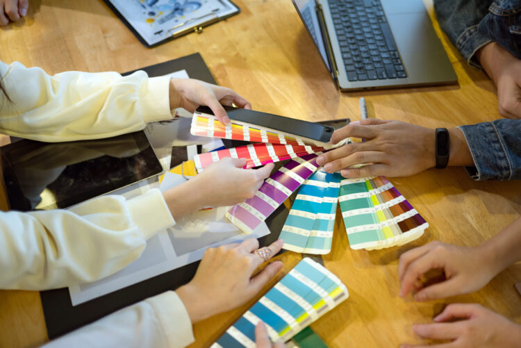 Team collaborating on color choices using swatches during a color consultation